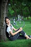 Portrait Of Young Woman With Blur Biclycle Background Relaxing I Stock Photo