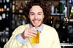 Positive Young Man Holding A Glass Of Beer Stock Photo