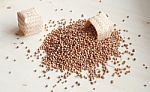 Pouring Spice Seed On The Wooden Board Stock Photo