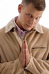 Praying Male Looking At Camera Stock Photo