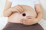 Pregnant Belly With Cherry Stock Photo