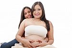 Pregnant Woman And Her Daughter Making A Heart Sign Stock Photo