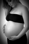 Pregnant Woman Holding Her Tummy Stock Photo