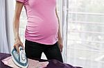 Pregnant Woman Ironing Stock Photo