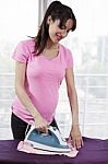 Pregnant Woman Ironing Stock Photo