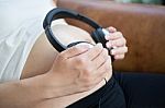 Pregnant Woman Listen To The Music Stock Photo
