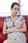 Pregnant Woman Relaxing On A Couch Stock Photo