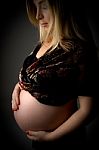 Pregnant Woman Touching Her Tummy Stock Photo