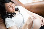 Pregnant Woman Using Stethoscope Stock Photo