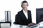 Pretty Business Woman Working At Office Wearing Headset Stock Photo