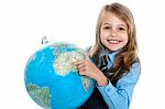 Pretty School Child Holding Globe And Pointing Stock Photo