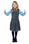 Pretty School Child Showing Thumbs Up Gesture Stock Photo