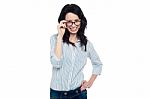 Pretty Woman Adjusting Her Spectacles Stock Photo