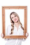 Pretty  Woman Posing Behind  Wooden Frame Stock Photo
