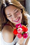 Pretty Woman With Flowers At Home Stock Photo