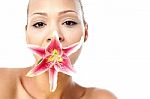 Pretty Woman With Lily Flower In Mouth Stock Photo