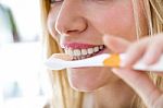 Pretty Young Blonde Woman Cleaning Her Teeth Stock Photo