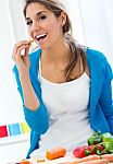 Pretty Young Woman Eating Salad At Home Stock Photo
