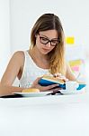 Pretty Young Woman Reading A Book And Having Breakfast At Home Stock Photo