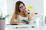 Pretty Young Woman Reading A Book And Having Breakfast At Home Stock Photo