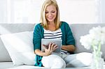 Pretty Young Woman Using Her Digital Tablet At Home Stock Photo