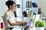 Pretty Young Woman Using Her Laptop In The Office Stock Photo