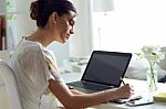 Pretty Young Woman Using Her Laptop In The Office Stock Photo