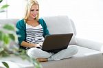 Pretty Young Woman Working With Laptop At Home Stock Photo