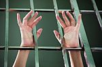 Prisoner Hands In Jail As Background Stock Photo