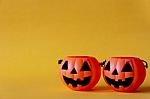 Pumpkins Bucket On Yellow Background , Halloween Background Stock Photo