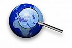 Puzzle Globe And Magnifying Glass Stock Photo