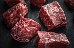 Raw Angus Beef Slices On The Black Stone  Table Horizontal Stock Photo