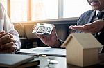 Real Estate Concept, Agent Holds Calculator For Present Price Fo Stock Photo