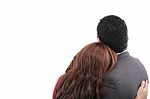 Rear View Of A Loving Couple Standing With Arms Around Stock Photo
