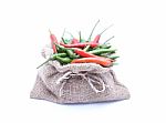 Red And Gren Chilli And Brown Bag With White Background  Stock Photo