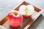 Red Apple On Wooden Tray Stock Photo