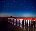 Red Bridge In The Night Sky With Star On Top Of The Sea Stock Photo