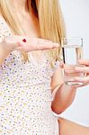 Red Capsule In Woman's Hand Stock Photo