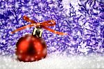 Red Christmas Ball On Snow With Christmas Tree Stock Photo
