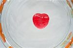 Red Heart Candy On The Glass Stock Photo