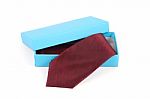 Red Necktie In A Blue Box Stock Photo