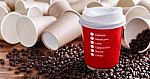 Red Paper Coffee Cup With Coffee Beans Stock Photo