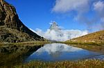 Reflection In The Riffelsee Of Matterhorn And Cloud Under With L Stock Photo
