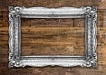 Retro Silver Gold Picture Frame On Wooden Wall Stock Photo