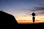 Road Sign Silhouette And Colorful Sunset Stock Photo