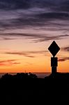 Road Sign Silhouette And Colorful Sunset Stock Photo