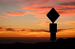 Road Sign Silhouette And Colorful Sunset Stock Photo