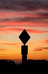 Road Sign Silhouette And Colorful Sunset Stock Photo