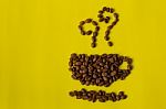Roasted Coffee Beans Placed In Shape Of A Cup On Yellow Backgro Stock Photo