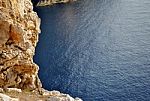 Rocky Coastline Overlooking A Blue Calm Sea Stock Photo